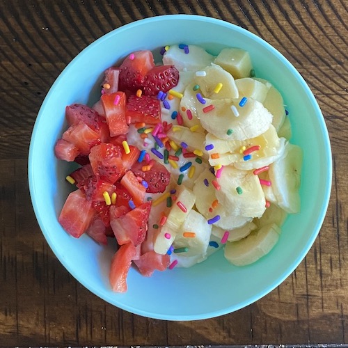 Toddler breakfast yogurt and fruit bowl.