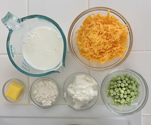 Toddler Mac & Cheese with peas ingredients: milk, cheese, butter, flour, yogurt, peas