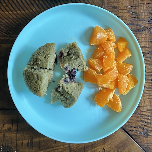 Toddler breakfast muffin with oranges.