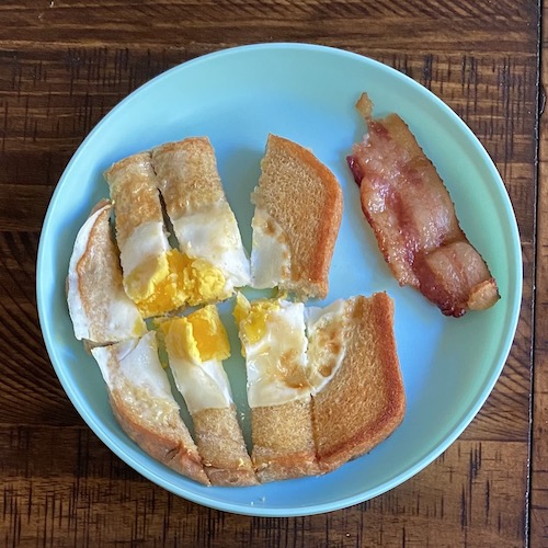 Toddler breakfast egg with bacon.